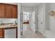 Hallway with kitchenette, bench seating and access to a bright primary bath at 104 Bellagio Dr, Apex, NC 27539