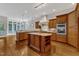 Spacious kitchen with custom wood cabinets, stainless steel appliances, and a center island at 104 Bellagio Dr, Apex, NC 27539