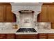 Modern kitchen range with custom wood cabinets, granite countertops and tiled backsplash at 104 Bellagio Dr, Apex, NC 27539
