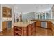 Open kitchen concept with island, stainless steel appliances, granite countertops and bar area at 104 Bellagio Dr, Apex, NC 27539