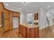 Kitchen island featuring granite countertop, custom cabinets and stainless steel appliances at 104 Bellagio Dr, Apex, NC 27539