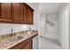 A well-equipped kitchenette with stone countertops, stainless steel mini-fridge and wooden cabinets at 104 Bellagio Dr, Apex, NC 27539