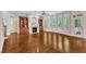 An open living room featuring a fireplace, built-ins, wood floors, and a wall of windows at 104 Bellagio Dr, Apex, NC 27539