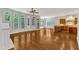 Bright living room with hardwood floors, large windows and kitchen area with wood cabinets at 104 Bellagio Dr, Apex, NC 27539