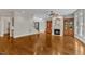 An open living room with a fireplace, built-in shelving, hardwood floors, and lots of windows at 104 Bellagio Dr, Apex, NC 27539