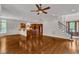Open-concept living area with hardwood floors, a staircase, and a partial view of the kitchen at 104 Bellagio Dr, Apex, NC 27539