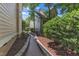 Landscaped side yard with brick path surrounded by stone edging and mulch at 104 Bellagio Dr, Apex, NC 27539