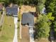 Aerial view of a home featuring a long driveway, manicured lawn, and surrounding lush greenery at 107 Mohave Dr, Louisburg, NC 27549