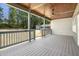 This covered back porch has a ceiling fan and overlooks a spacious backyard, offering a peaceful outdoor living space at 107 Mohave Dr, Louisburg, NC 27549