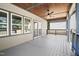 The open-air back porch of this home features a ceiling fan, railings, and plenty of space for outdoor furniture at 107 Mohave Dr, Louisburg, NC 27549