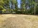 Expansive backyard area with new construction featuring tree line on this wooded property at 107 Mohave Dr, Louisburg, NC 27549