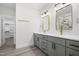 Bathroom vanity with double sinks, white countertop and sage green cabinets at 107 Mohave Dr, Louisburg, NC 27549