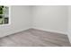 Bedroom with gray wood floors and a window with a view at 107 Mohave Dr, Louisburg, NC 27549