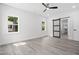 Bedroom featuring light gray flooring, barn door, and three windows at 107 Mohave Dr, Louisburg, NC 27549