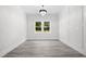 Sun-filled bedroom featuring modern chandelier, light gray flooring, and decorative molding at 107 Mohave Dr, Louisburg, NC 27549