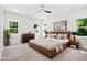 Bedroom boasts natural light, ceiling fan, light wood flooring, and ample space at 107 Mohave Dr, Louisburg, NC 27549