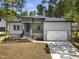 Charming home featuring stone accents, a two-car garage, and a welcoming front porch at 107 Mohave Dr, Louisburg, NC 27549