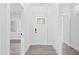 This bright foyer features a decorative glass-paneled front door and leads to the home's living spaces at 107 Mohave Dr, Louisburg, NC 27549