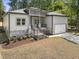 New construction exterior showcasing stone accents, well-manicured lawn, and an attached garage at 107 Mohave Dr, Louisburg, NC 27549