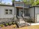 New construction exterior showcasing stone accents, well-manicured lawn, and a covered porch at 107 Mohave Dr, Louisburg, NC 27549