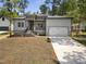 Charming front exterior of a new construction home with a two car garage and stone accents at 107 Mohave Dr, Louisburg, NC 27549
