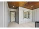 Covered front porch featuring a stylish front door, recessed lighting, and craftsman style trim at 107 Mohave Dr, Louisburg, NC 27549
