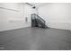 This clean garage has epoxy floors, ample lighting and a staircase to an upper level at 107 Mohave Dr, Louisburg, NC 27549