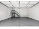 This spacious garage has epoxy floors, ample lighting and a staircase to an upper level at 107 Mohave Dr, Louisburg, NC 27549
