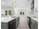 Modern kitchen features island, quartz countertops, stainless steel appliances, and eat-in area at 107 Mohave Dr, Louisburg, NC 27549