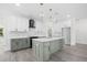 Open kitchen featuring stainless steel appliances, a central island, and modern cabinetry at 107 Mohave Dr, Louisburg, NC 27549