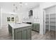 Modern kitchen with an island, pendant lights, and marble countertops at 107 Mohave Dr, Louisburg, NC 27549