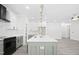 Kitchen with a large island, modern appliances, and stylish fixtures at 107 Mohave Dr, Louisburg, NC 27549
