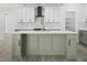 Contemporary kitchen featuring a marble backsplash, an island, and modern pendant lighting at 107 Mohave Dr, Louisburg, NC 27549