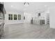 Bright living room features a stone fireplace and transitions to a modern kitchen at 107 Mohave Dr, Louisburg, NC 27549