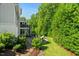 Backyard view featuring a patio with seating area, lush landscaping, and mature trees at 109 Greenock Ct, Cary, NC 27511