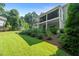 Expansive green lawn with mature landscaping and a tiered deck perfect for relaxation at 109 Greenock Ct, Cary, NC 27511