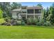 Sprawling backyard with manicured lawn, and tiered decks overlooking a lush green landscape at 109 Greenock Ct, Cary, NC 27511