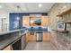 Stylish bar area with a mini fridge, wooden cabinets, and a brick accent wall at 109 Greenock Ct, Cary, NC 27511