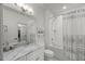 This clean bathroom features a vanity with marble countertop and tub-shower with patterned curtain at 109 Greenock Ct, Cary, NC 27511