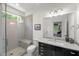 A bright bathroom offers a glass-enclosed shower, toilet, and granite countertop vanity with under-cabinet storage at 109 Greenock Ct, Cary, NC 27511