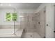 This clean bathroom design features a tub, shower, and bright window with verdant view at 109 Greenock Ct, Cary, NC 27511