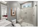 Contemporary bathroom features an open glass shower with seat, vanity, and toilet at 109 Greenock Ct, Cary, NC 27511