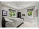 This modern bedroom has neutral-toned walls and carpet with ample light from the surrounding windows at 109 Greenock Ct, Cary, NC 27511