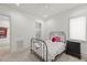 Minimalist bedroom design with iron bed frame, dark wood nightstand, and access to bathroom at 109 Greenock Ct, Cary, NC 27511