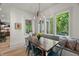 Charming dining area featuring a rustic table, bench seating, and views of the greenery outside at 109 Greenock Ct, Cary, NC 27511
