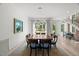 Open dining room featuring hardwood floors, modern lighting, and multiple windows for lots of natural light at 109 Greenock Ct, Cary, NC 27511