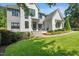 Beautiful home featuring a combination of white brick and gray siding, complemented by lush landscaping at 109 Greenock Ct, Cary, NC 27511