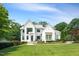 Stunning two-story home featuring a landscaped front yard and a blend of white brick and gray siding at 109 Greenock Ct, Cary, NC 27511