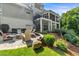 Exterior view of a multi-level home with covered patios, spiral staircase, and landscaped yard at 109 Greenock Ct, Cary, NC 27511