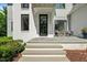 Charming front entryway with gray stairs and comfortable outdoor seating area at 109 Greenock Ct, Cary, NC 27511